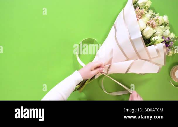 Curated visual reference: Usability Focused Bow Formation In Knots Reference: Hands Secure A White Ribbon Knot Around A Completed Flower