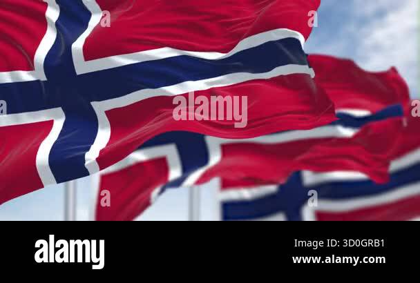 Norway national flags waving in the wind on a clear day. Red field with ...