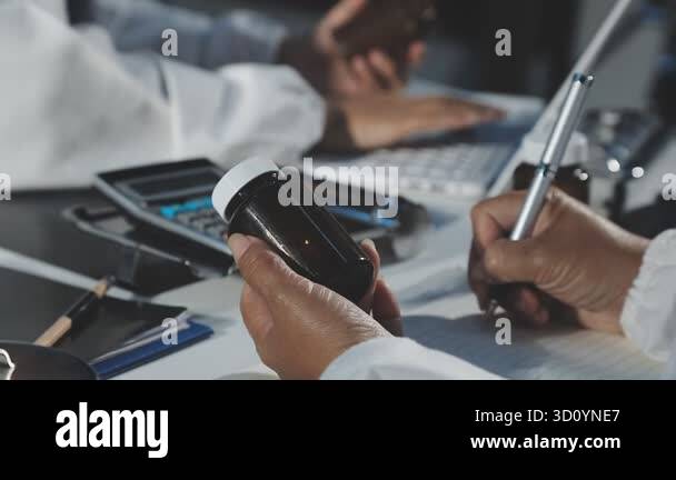 close up view of businessman hand holding pen and using smartphone ...