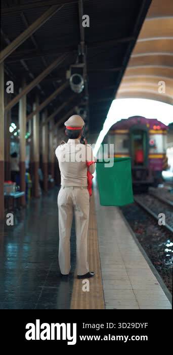 railroad station dispatcher giving green signal for train departure ...