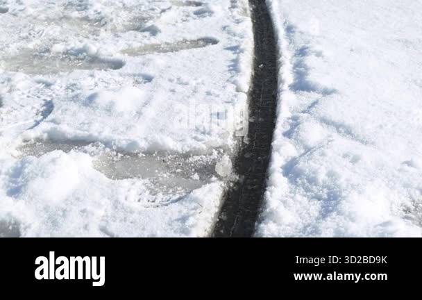 Ice disk rotates in the river water, cut by the current. A close-up of ...