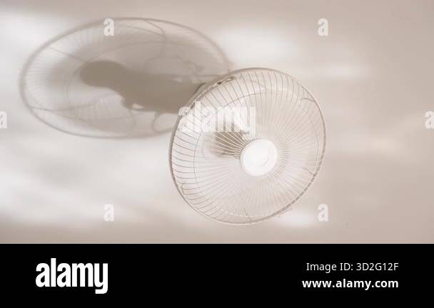 Close Up Ceiling Fan Mounted on Wall with Visible Shadow and Sunlight ...