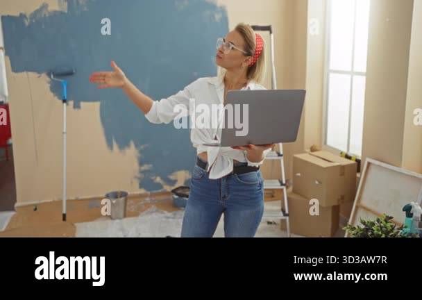 Woman thinking in new home, using laptop while planning interior design ...