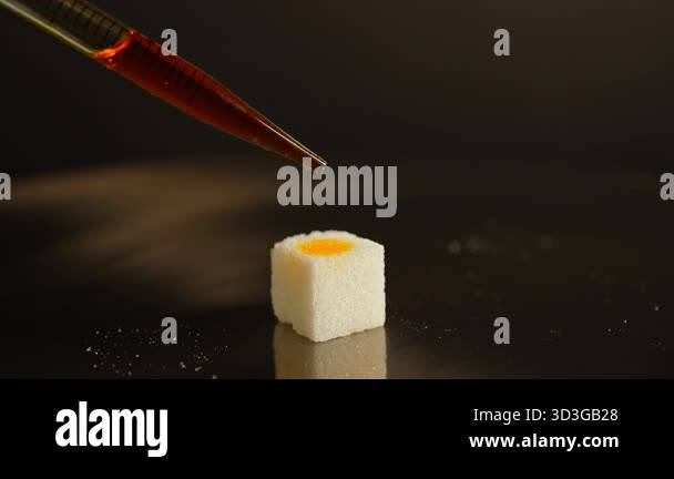 LSD in liquid dropped from pipette to sugar. Lysergic acid diethylamide ...