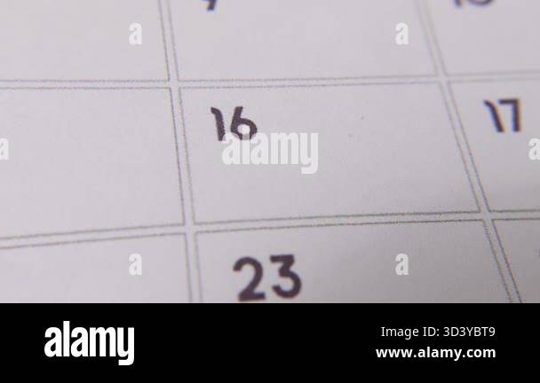 The 16th on the calendar is circled in red marker in a close-up macro ...
