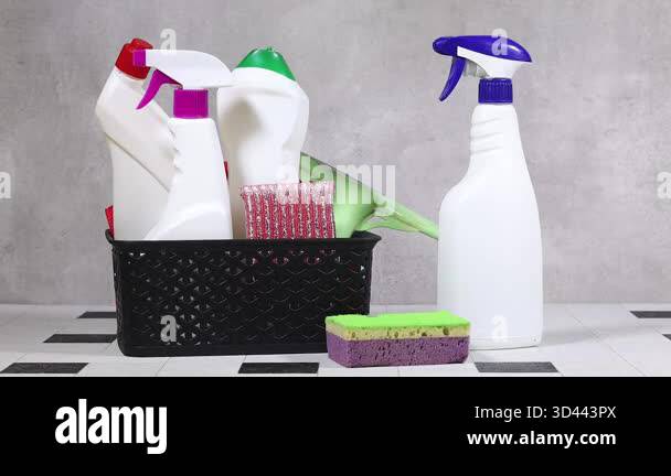 Cleaning Supplies In A Black Basket With Spray Bottles, Sponges, And ...