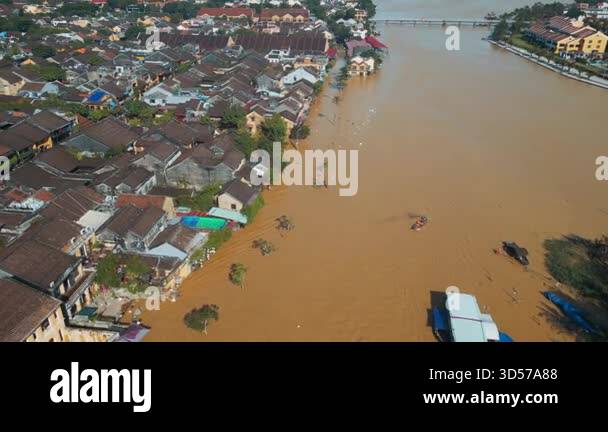 Submerged Overflow flooded city or town with buildings submerged in overflow water and mud ...