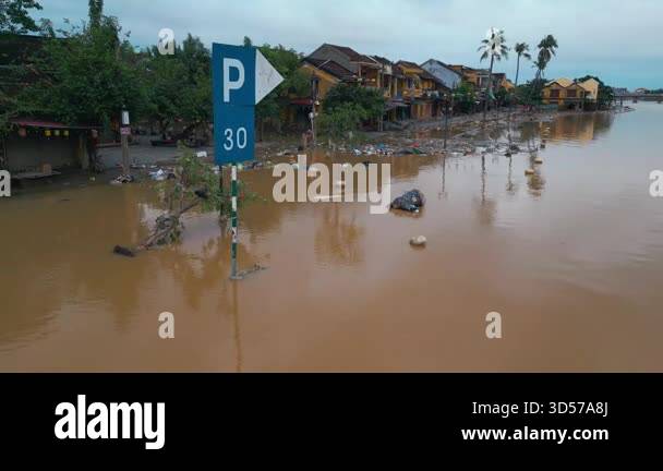 Submerged Overflow flooded city or town with buildings submerged in overflow water and mud ...