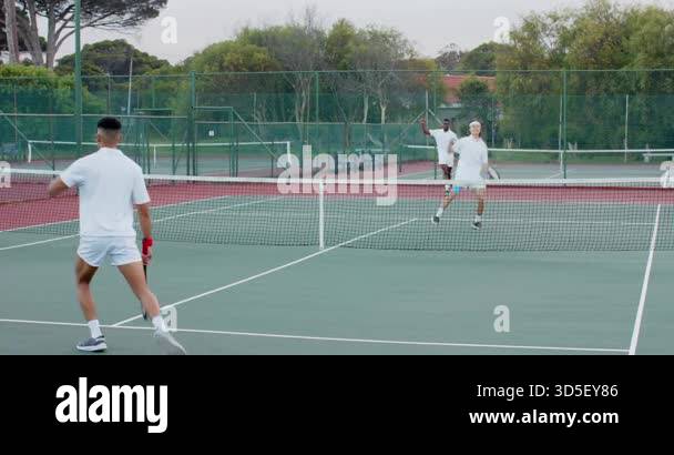 Tennis Rallying Serving Diverse male tennis players sparking backhand rally on court ...