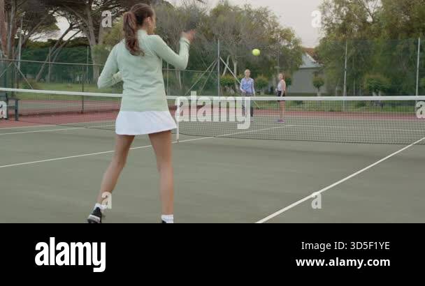 Tapping Tennis Rackets Female friends rallying tennis ball serving volleying lobbing tapping ...