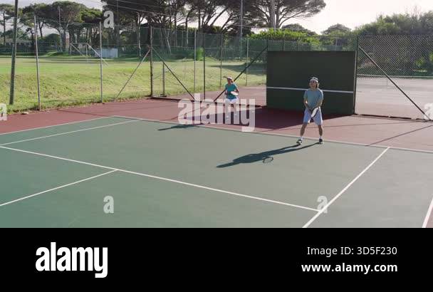 Starting rally off wall, Diverse players warming up on court with ...
