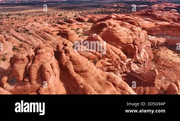 Footage over the sunlit red rounded rocks. Deserted landscape covered ...
