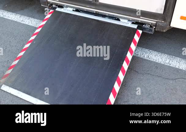 Accessible public transport bus extending an automated ramp to provide ...