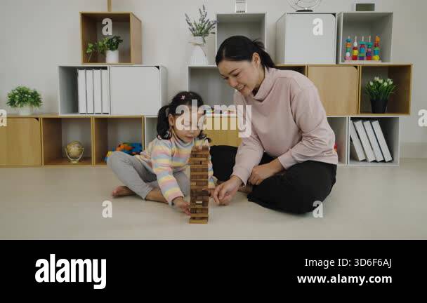Toddler Girl With Her Mother Playing Wooden Block Toy Together And
