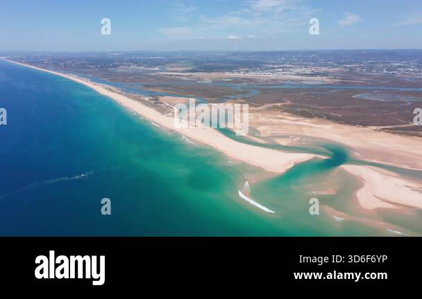 surveyor observes tranquil shoreline from above, drone captures serene ...