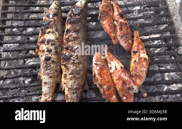El Jem, Tunisia Fish grilling on an outdoor grill in the souk or Medina ...