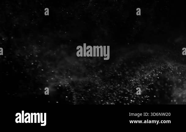 Particles and dust in the air on a black background. Filmed on a high ...