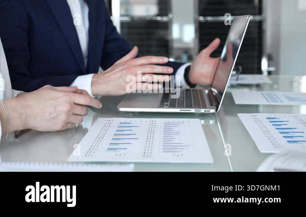 Business partners engaging in a serious discussion, negotiating terms ...