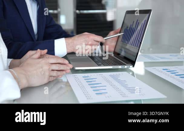 Business partners engaging in a serious discussion, negotiating terms ...