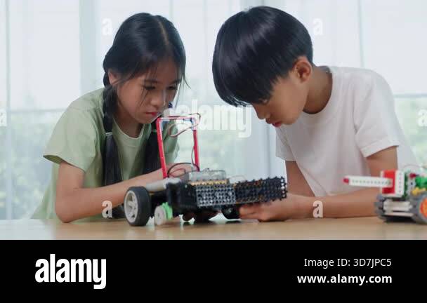 Asian children engineer working on robotics project in a STEM education ...