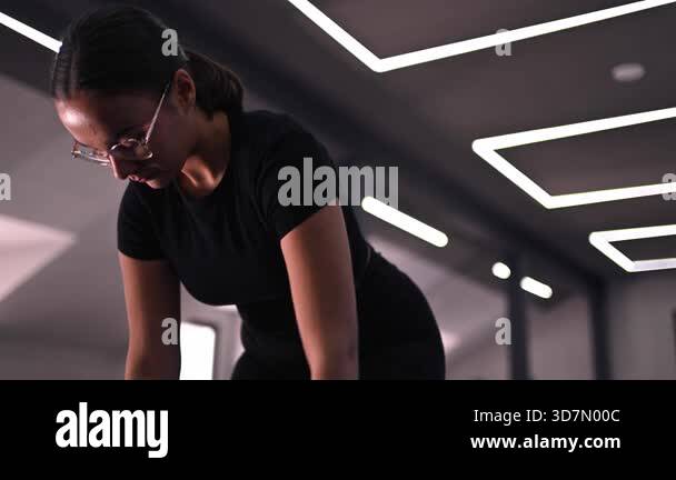 In this gym session, a woman focuses on strength training, performing ...