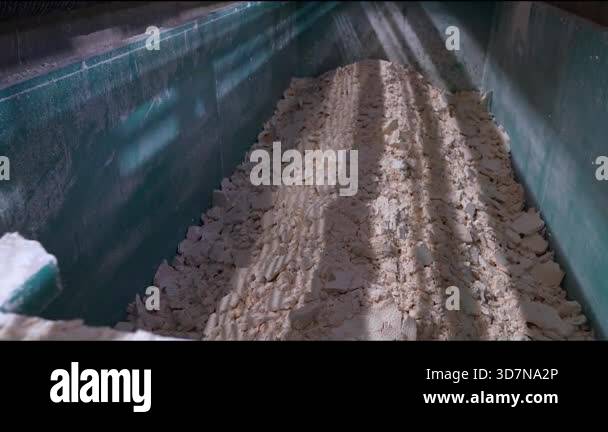 Industrial setting features synthetic gypsum in a processing container ...