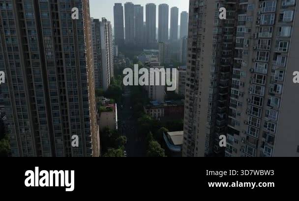Aerial view looking down a straight city road lined symmetrically by ...