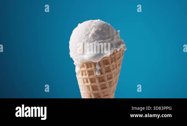 vanilla ice cream in waffle cone turning on blue background Stock Video ...