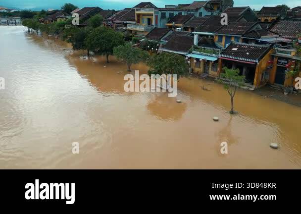 Submerged Overflow flooded city or town with buildings submerged in overflow water and mud ...