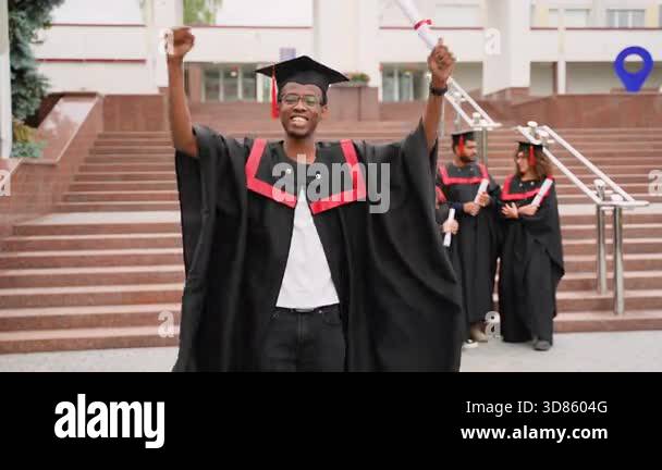 Proud african american male student in a graduation gown and cap ...