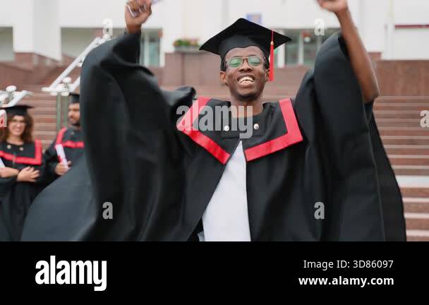 Proud african american male student in a graduation gown and cap ...