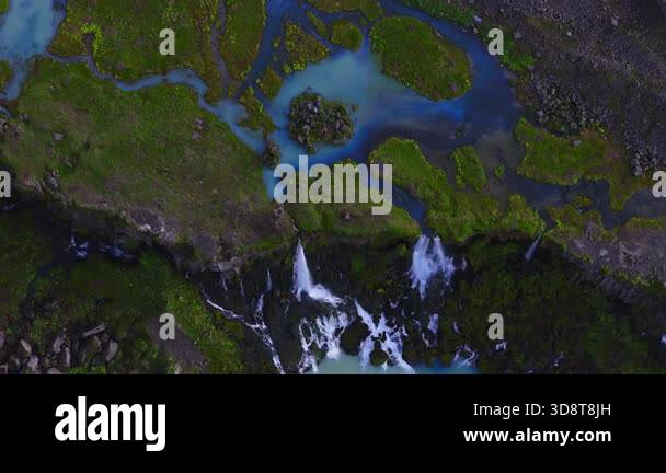 Drone top down view shows milky turquoise meltwater in Iceland, braided ...