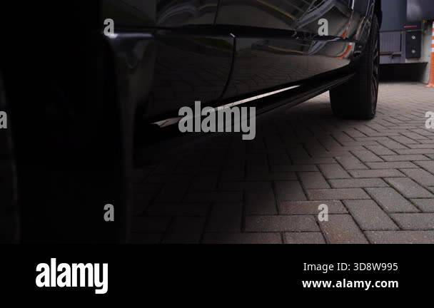 Low angle close up pans along a Range Rover Autobiography as the ...