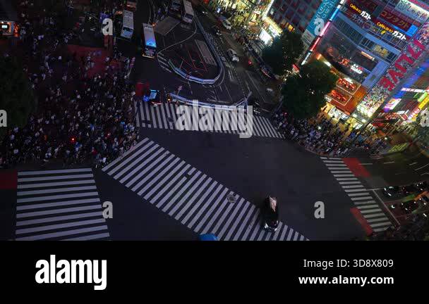 High angle aerial view shows Shibuya Scramble Crossing at night in ...