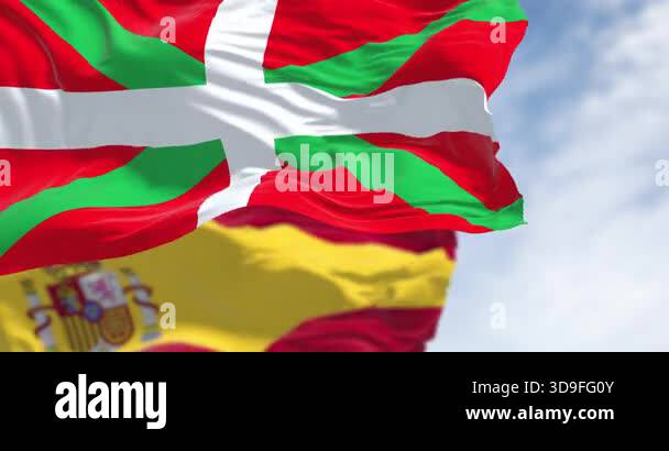 Basque Country and Spanish flags waving in the wind on a clear day ...