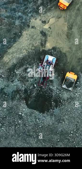 Scraping Rig aerial rig and excavator working in pit with synchronized digging ...