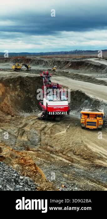 aerial open pit excavation excavator truck loading rocks into dumper ...
