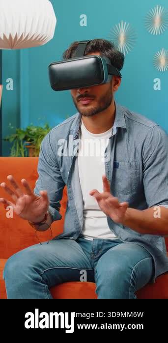Indian man using virtual reality futuristic technology VR app headset ...