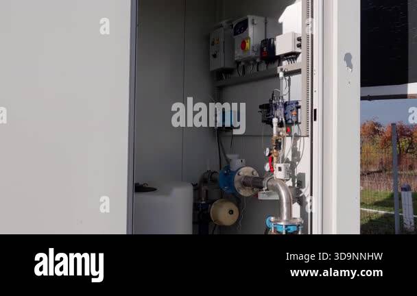 Industrial control panel features various components and piping ...