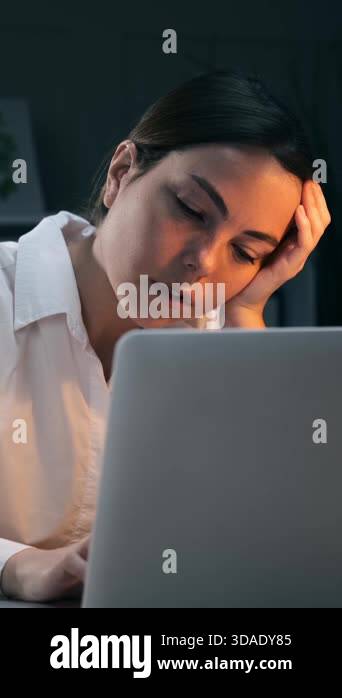 Exhausted young businesswoman leaning on hand and struggling to stay ...