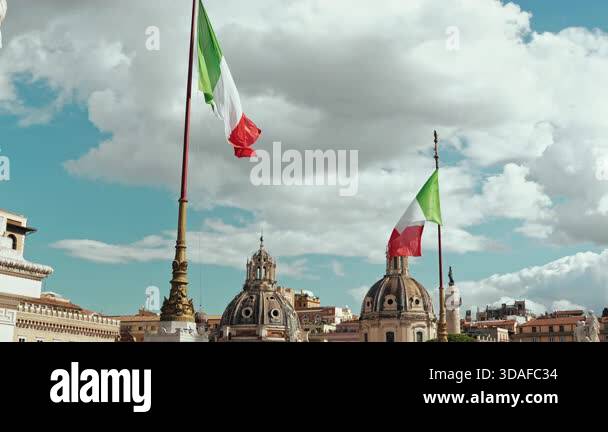 Italian flags waving above rooftops of Rome with historic domes and ...