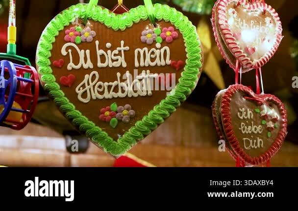 A closeup of decorated gingerbread heart cookies with german messages ...