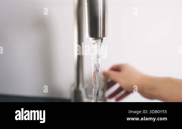 close up shot person hand using faucet opening tap with wateropening ...