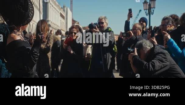 VENICE, ITALY - MARCH 05 2025: Tourists group take pictures of ...