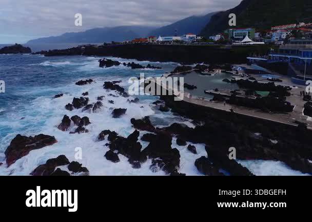 Aerial view shows black lava rock tidal pools, seawall promenade ...