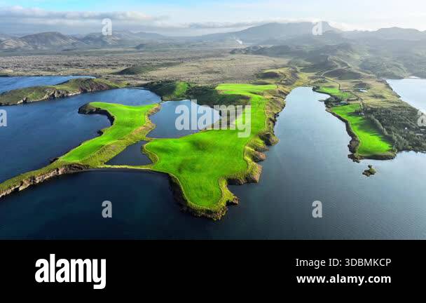Aerial drone view of a small green island surrounded by deep blue ocean ...