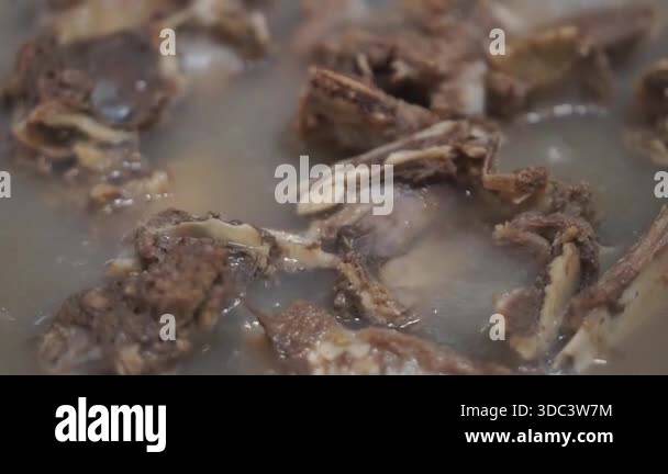 Boiling beef meat for food preparation, commonly used as a base ...