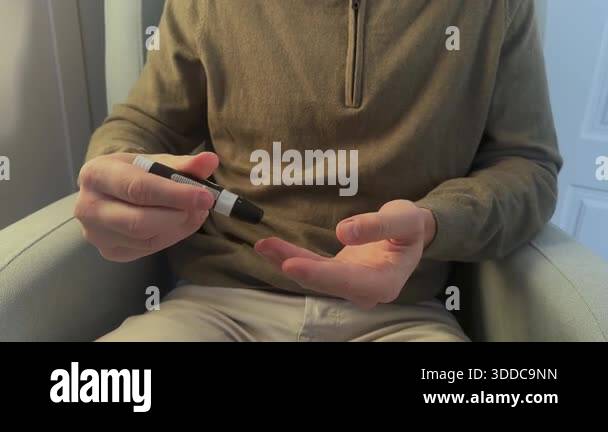 Man Using Glucometer Man with diabetes testing his blood sugar level at home. Patient using ...