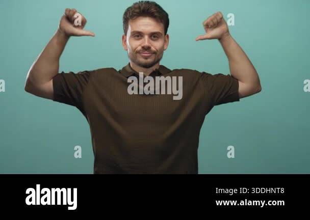 Man pointing both thumbs to his chest while smiling, visible hands and ...
