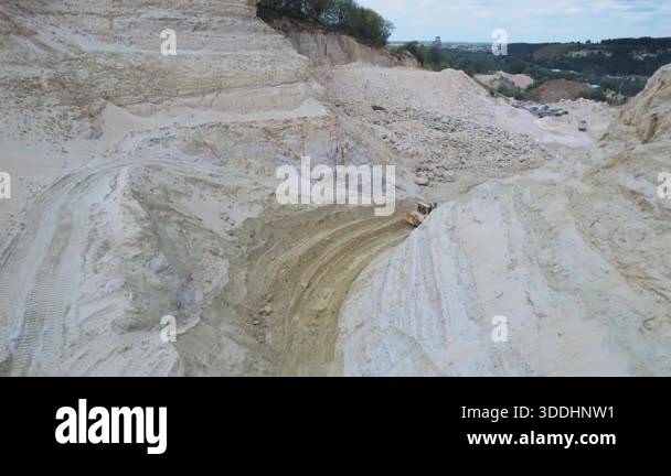 Excavator and quarry aggregate working on sand quarry. Drone shot of ...